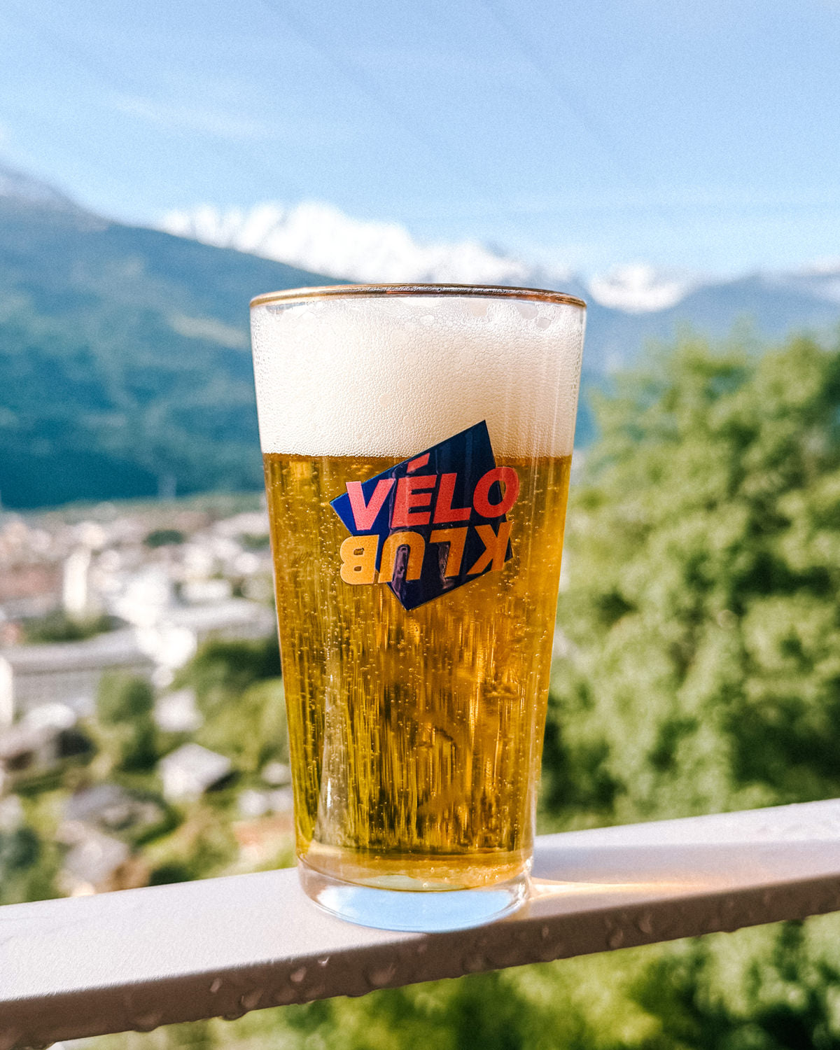 Set of six Vélo Klub glasses on a balcony