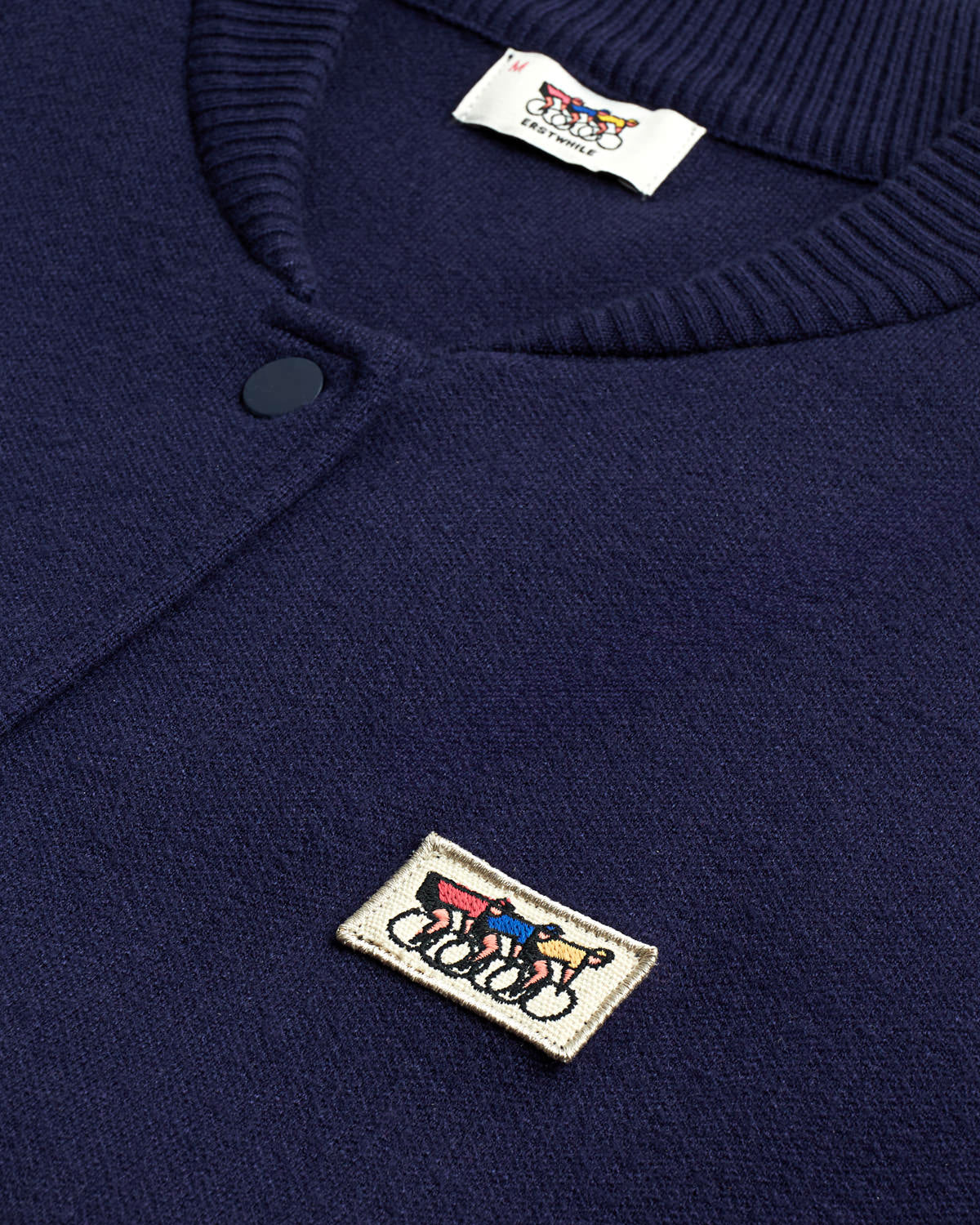 Close-up of the navy varsity jacket