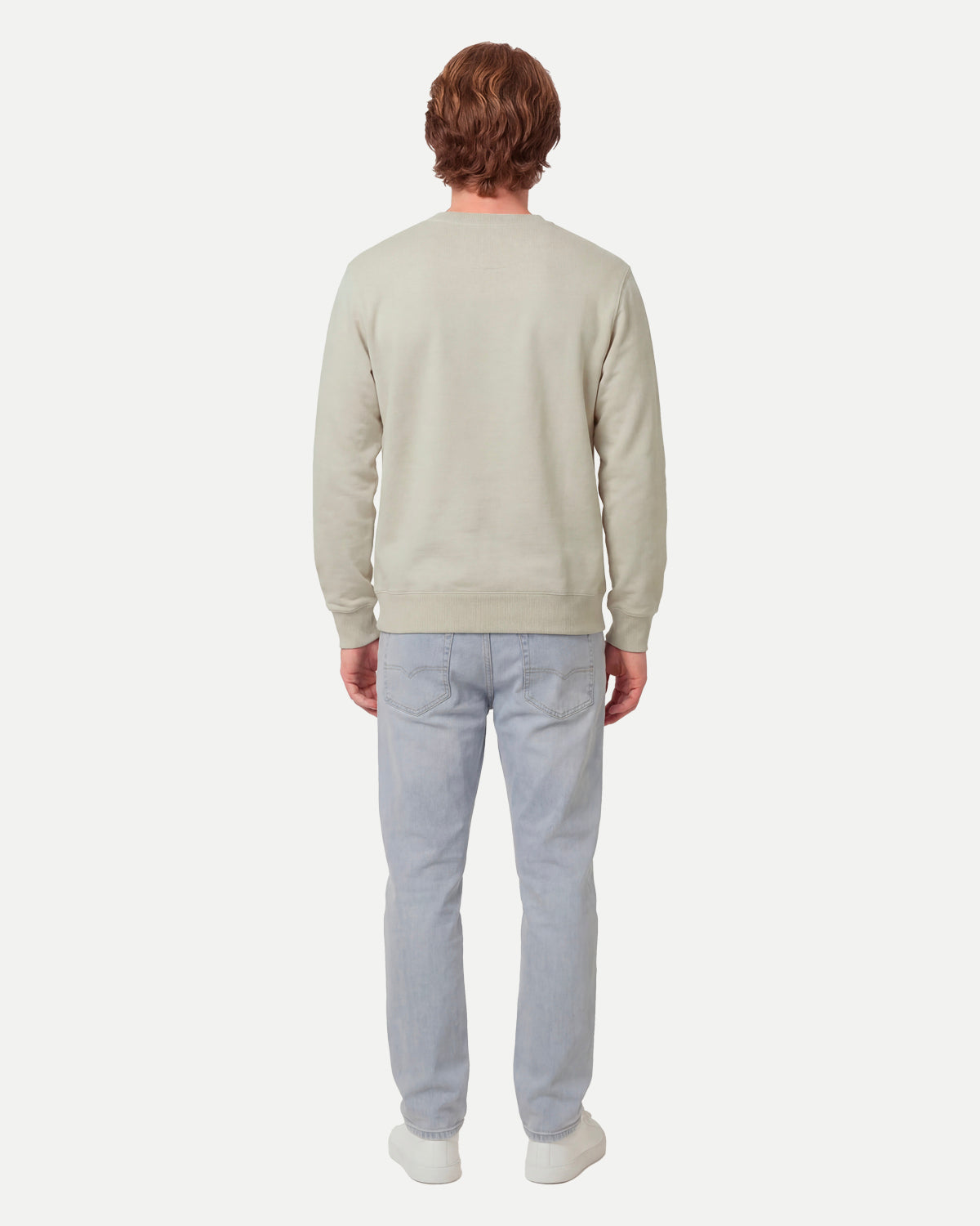 Model wearing the faded olive Waaier sweatshirt, seen from the back