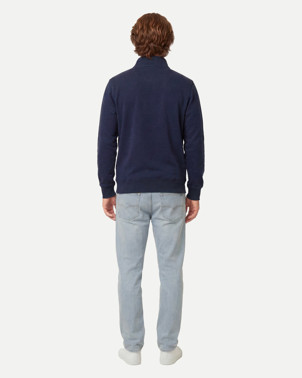 Model wearing the navy zip sweatshirt, seen from the back